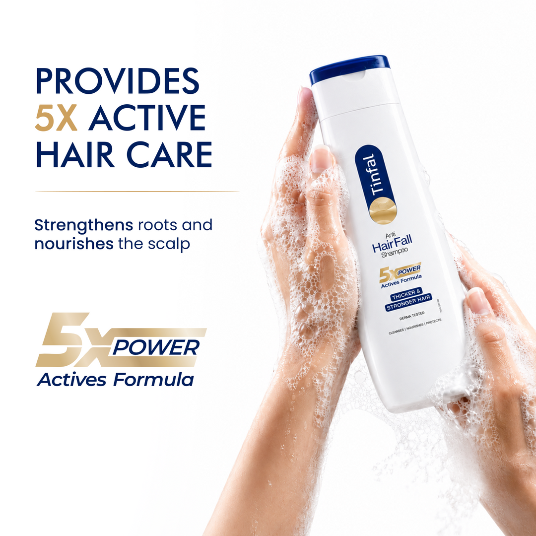 A bottle of tinsley hairfall strengthen shampoo is held by two hands