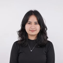 A woman with shoulder-length black hair wearing a black long-sleeve top 