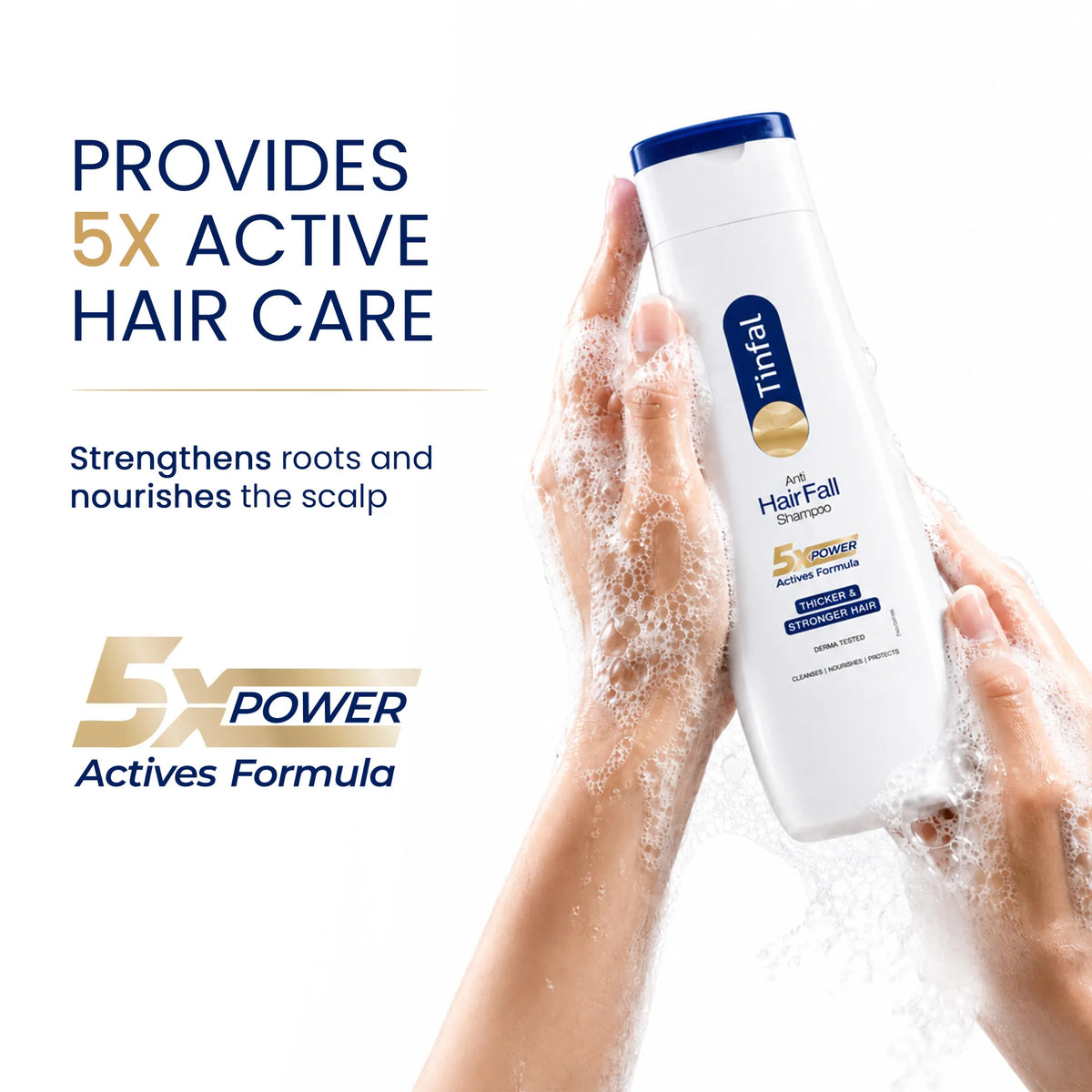 Hands covered in soapy lather holding a bottle of tinfal anti hair fall shampoo